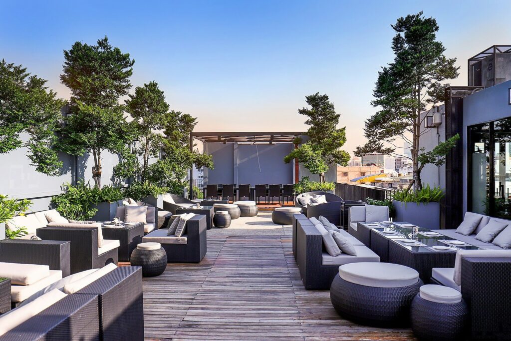 Rooftop hotel deck with artificial foliage, greenery and trees