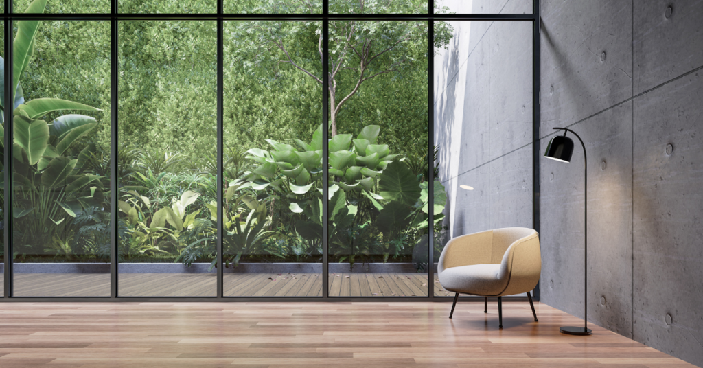 Image of a industrial style residential or office setting with an outdoor patio that has a uv blocking artificial green wall